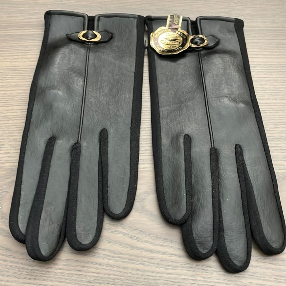 Womens NEW in package black fleece lined fine grain simulated leather gloves.